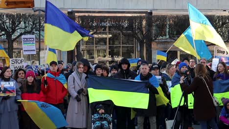 People-with-Ukrainian-flags-at-anti-war-protest-in-Stockholm,-Sweden