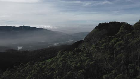 aerial-drone-view-drone-camera-is-moving-towards-the-front-where-big-rivers-and-big-forest-area-are-visible-there-are-also-many-road-roads-and-small-bushes-are-also-visible-on-the-hill