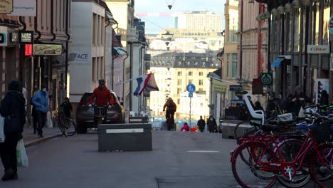 Pedestrians-and-bicyclists-move-around-on-street-in-Stockholm,-static
