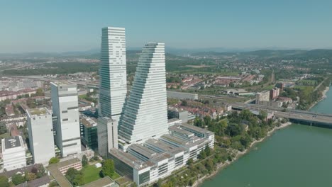 Aerial-flies-over-Rhine-river-in-Basel-with-the-two-Roche-Towers-and-kleinbasel-in-frame