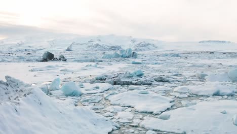 4K-drone,-aerial,-and-cinematic-landscape-shots-of-broken,-chunks,-of-glaciers-in-the-Icelandic-sea