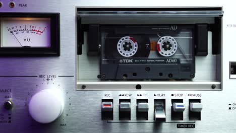 Close-Up-of-Vintage-Audio-Cassette-Tape-Playing-in-Gray-Deck-Player