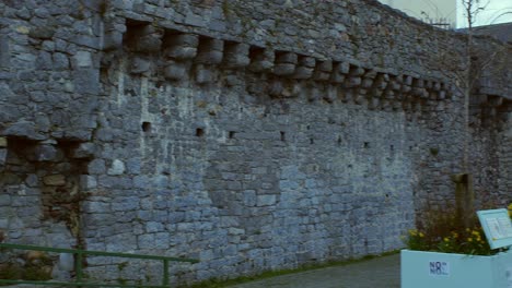 Pan-shot-of-Spanish-Arch-revealing-medieval-old-wall-and-arch