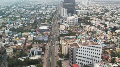 Aerial-Drone-Shot-of-Corporate-Buildings-In-the-middle-of-city-filled-with-traffic