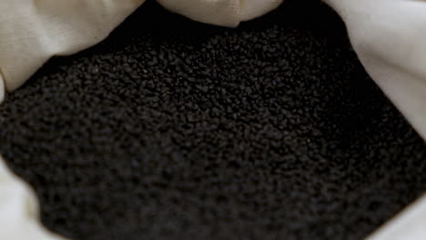 Full-bag-of-black-basil-seeds,-close-up-shallow-focus