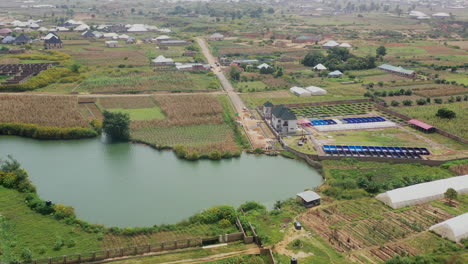 Ponds-feeding-into-fishery-tanks-in-Jos-Town,-Nigeria---aerial