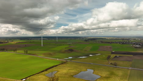 Aerial-establishing-shot-of-rural-farm-fields-with-flooded-ponds