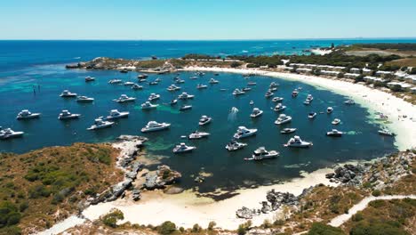 aerial-drone-over-geordie-bay-on-Rottnest-Island-with-a-lot-of-yacht-on-a-sunny-day,-western-australia