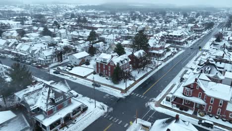 Snow-covered-town-with-rows-of-houses-and-a-main-road