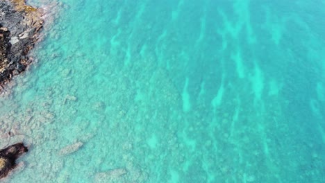 Amazing-aerial-drone-video-of-a-free-diver-swimming-in-tropical-Hawaiian-exotic-destination-with-turquoise-calm-ocean-surface