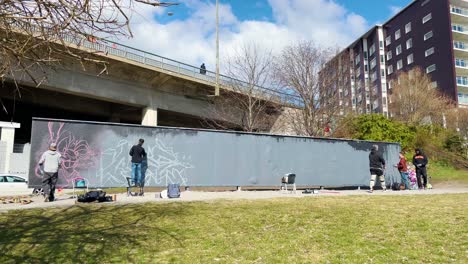 Artists-prepare-art-on-blank-legal-graffiti-wall-in-Stockholm,-Sweden