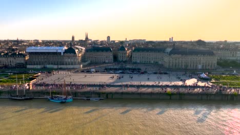 Place-de-la-Bourse-Square-home-of-Chamber-of-Commerce-during-morning-in-Bordeaux-France,-Aerial-dolly-in-shot