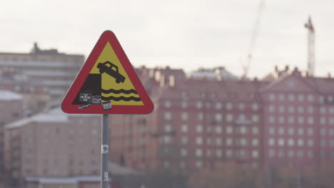 Traffic-road-sign-warning-motorists-of-crashing-into-water-at-harbour