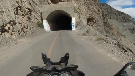 Moto-POV:-Riding-motorcycle-through-dark-tunnel-on-mountain-highway