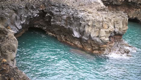 Natural-sea-cave-among-the-rocks-on-a-calm-day