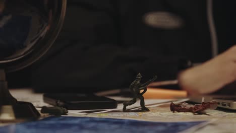 toy-soldier-and-cell-phone-on-the-table-slow-motion