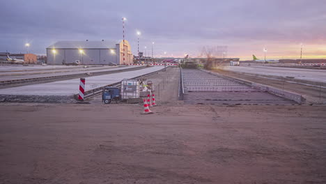 Time-Lapse-of-heavy-machines-building-pavement-at-a-airport-construction-site