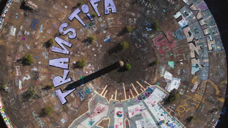 Top-Down-Aerial-View,-Graffiti-in-Circular-Thickener-of-Three-Kids-Mine,-Abandoned-Open-Pit-Near-Henderson-NV-USA