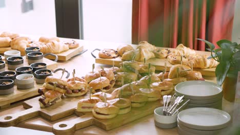 Breakfast-buffet-spread-with-oats,-pastries,-and-hot-breakfast-sandwiches,-ready-for-morning-indulgence