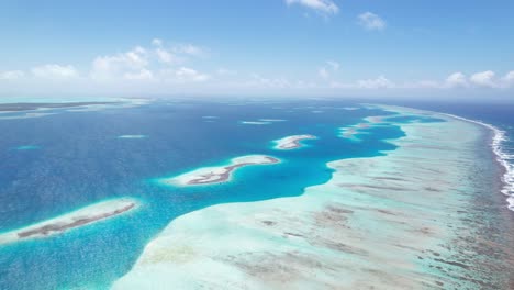 The-eastern-barrier-of-los-roques-with-clear-blue-waters,-aerial-view