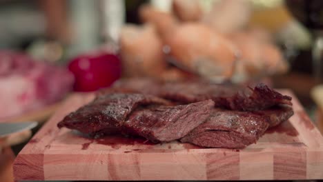 Close-up-still-shot-of-some-cuts-of-juicy-freshly-roasted-meat-on-a-wooden-board