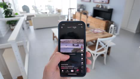 Opening-TikTok-App-on-Smartphone-to-Watch-Videos-and-Scrolling-with-Thumb