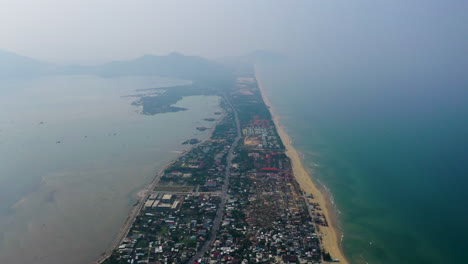 High-aerial-view-flying-along-the-scenic-coastline-of-Hoi-An,-Vietnam