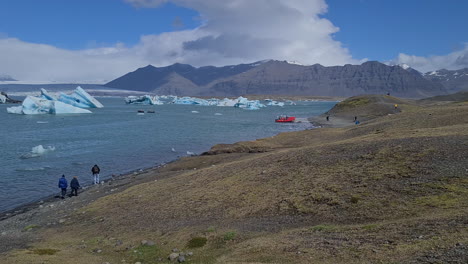 Jokulsarlon-Glacial-Lagoon,-Iceland,-Tourist-on-Coast,-Icebergs-in-Lake-Water,-Panorama