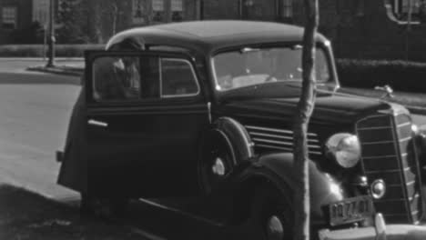 Woman-Boards-a-Classic-Car-Parked-in-Front-of-Her-House-in-the-1930s