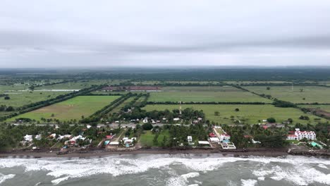 Drone-shot-of-Veracruz-beach-and-fields-and-houses