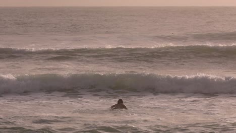 Morning-views-of-a-surfer-paddling-out-at-Burleigh-Heads,-Gold-Coast,-Australia