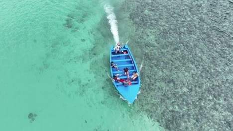 Boat-with-tourists-on-board-departing-from-Playa-Caleton-beach-in-Dominican-Republic