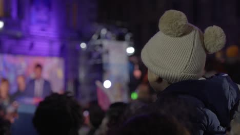 Father-Carrying-Child-on-Shoulders-at-Crowded-Event