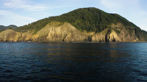 Full-shot-of-small-mountain-peak-along-remote-stretch-of-Oregon-Coast