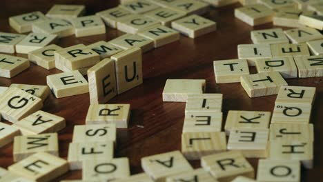 Right-hand-places-letter-tiles-onto-table-top-to-form-the-word-EURO