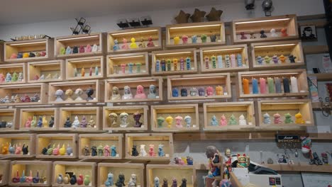 Eclectic-candle-collection-on-wooden-shelves-in-La-Candela-Store,-Venice