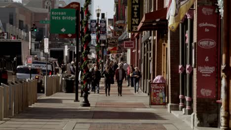 Tourists-on-Broadway-Street-in-Nashville,-Tennessee-during-the-day-with-wide-shot-video-stable