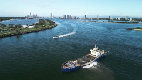 Sand-dredging-vessel-positioned-in-a-busy-city-ocean-inlet-for-a-coastal-rejuvenation-project