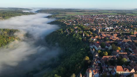 Rothenburg-Ob-Der-Tauber-Town-and-Foggy-River-Valley-in-Bavaria,-Germany---Aerial-4k