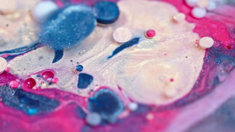 Close-up-of-vibrant-ink-drops-in-water-with-swirling-patterns-and-abstract-shapes