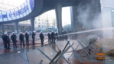 Belgian-riot-police-protecting-the-European-Parliament-building-during-manifestation-of-angry-farmers-in-Brussels,-Belgium