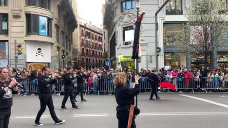 Celtic-band-of-musicians-playing-while-parading-in-Gran-Via-street,-Madrid