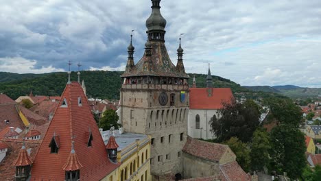 Sighisoara-Clock-Tower-in-Transylvania,-Romania---Aerial-4k-Circling