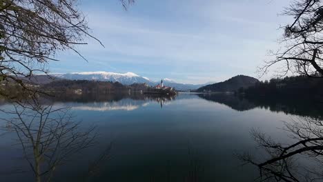 Aerial-forward-shot-of-a-lake-between-trees-during-daytime