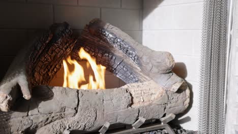 Warm-cozy-burning-fire-in-a-brick-fireplace,-close-up-shot