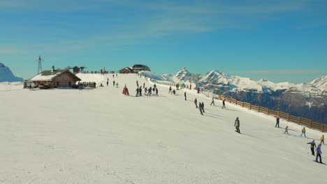 Skiers-gliding-down-snowy-slopes-at-Flaine-ski-resort,-French-Alps,-wide-angle-view