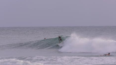 Morning-views-of-a-surfer-in-big-waves-at-Burleigh-Heads,-Gold-Coast,-Australia