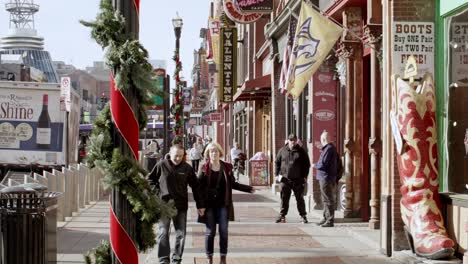 Tourists-on-Broadway-Street-in-Nashville,-Tennessee-during-the-day-with-close-shot-video-stable