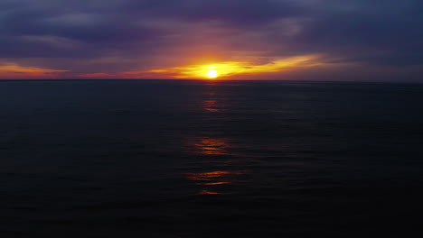 Glowing-sun-just-above-horizon-before-setting-over-Pacific-Ocean-off-Oregon-Coast