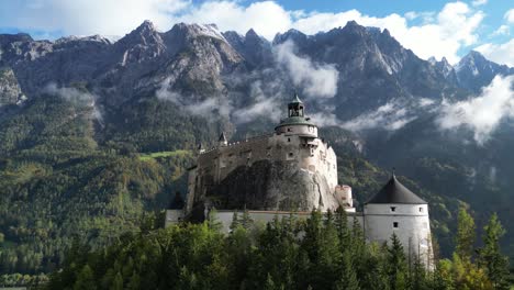 Hohenwerfen-Castle-with-Austria-Alps-Mountains-in-Background---Aerial-4k